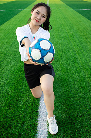 女生单人跪姿足球运动场人物照片