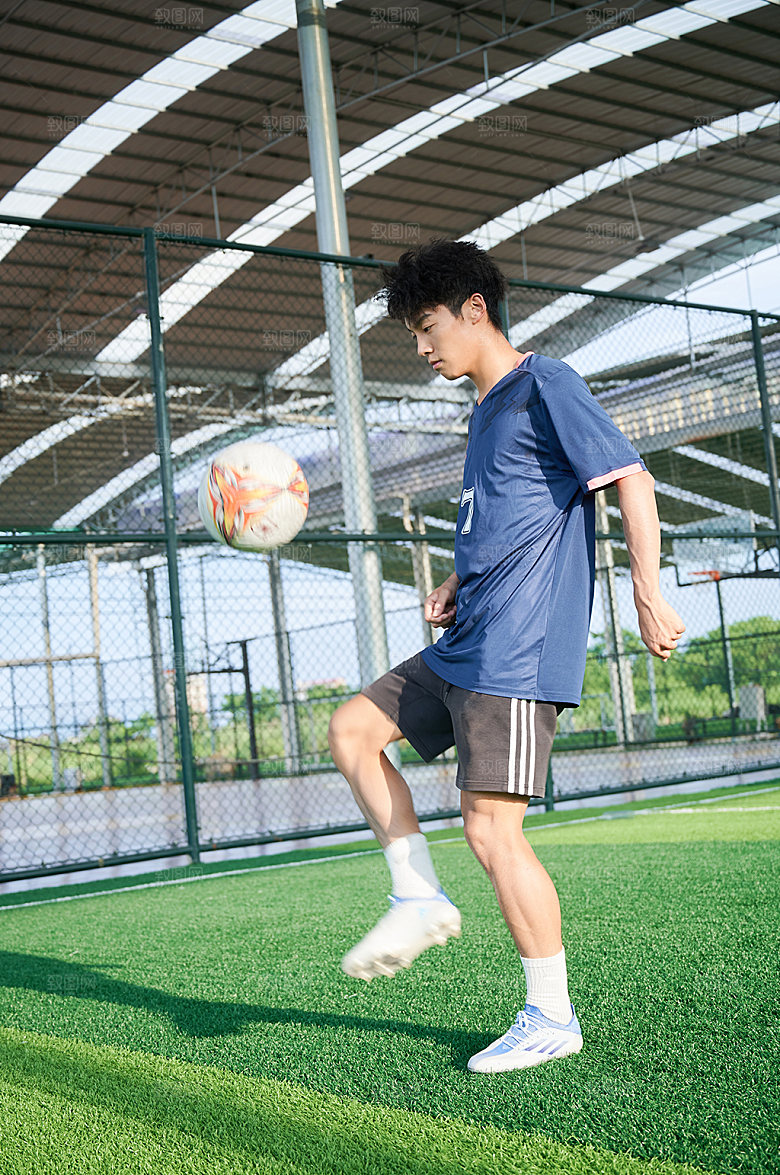 男生足球运动颠球人物摄影图