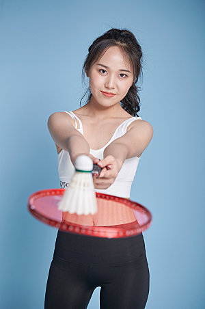 女生打羽毛球运动商业摄影图