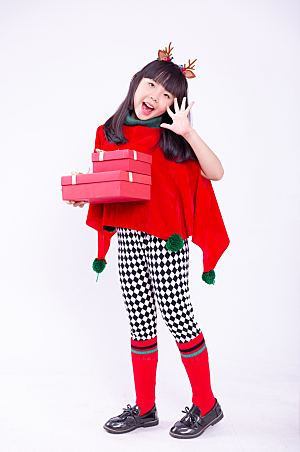 时尚抱着礼物盒的圣诞小女孩摄影图图片