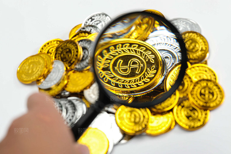 金币放大镜观察金融摄影图